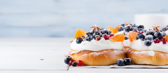 Canvas Print - Closeup of sweet buns with cottage cheese blueberry and persimmon slice on white wooden table with copy space image