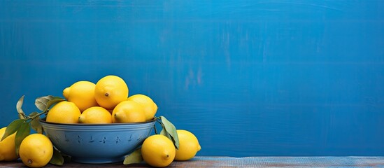 Sticker - A vibrant scene with a big plate of colorful lemons on a blue table at a cafe featuring a copy space image