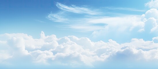abstract soft blue sky with white clouds creating a blurry backdrop with ample copy space image for 