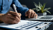 © Ekkarat_Studio - A man holding pen is doing checklist.