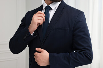 Wall Mural - Businessman in suit and necktie indoors, closeup