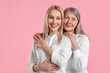 © New Africa - Family portrait of young woman and her mother on pink background