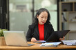 © Prathankarnpap - Professional senior woman accounting manager checking financial documents at workplace
