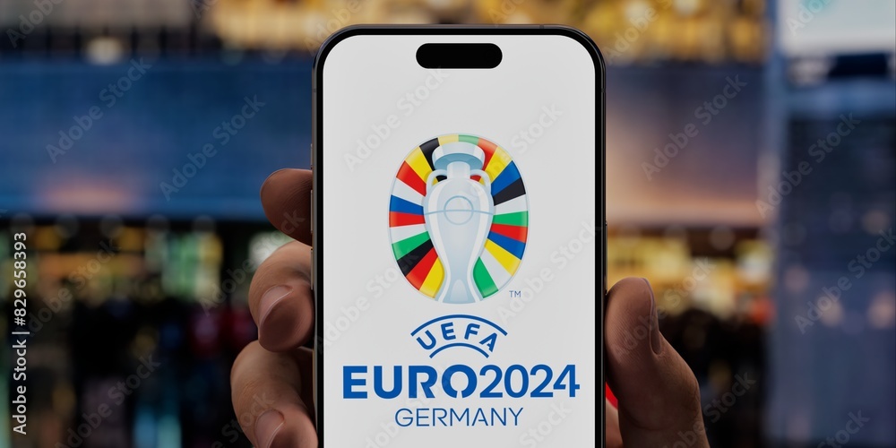 Fan holding a phone with the UEFA Euro 2024 app on a screen, against ...
