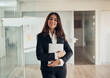 © Flamingo Images - Smiling businesswoman standing at the door of an office boardroom