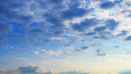 Wall Mural - Clouds at different heights move in different directions. An unusual atmospheric phenomenon. The sky at sunset with a pink tint.