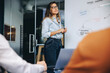 © Jacob Lund - Woman presenting her strategy in front of her team in a business meeting