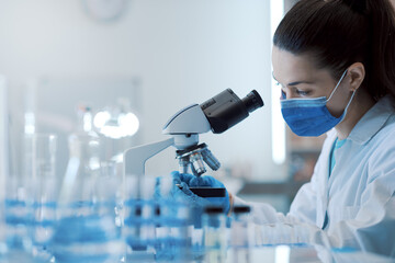 Wall Mural - scientist examining samples under a microscope