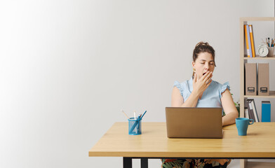 Wall Mural - Sleepy woman yawning in the office