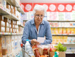 © StockPhotoPro - Senior lady doing her shopping at the supermarket
