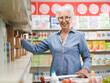 © StockPhotoPro - Senior woman buying groceries at the supermarket