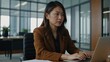 © LIFE LINE - Asian business woman working on a laptop in a professional office