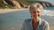 © LIFE LINE - Smiling mature woman at the beach, happy, joyful, enjoying sunny weather near the ocean, natural and relaxed senior lifestyle