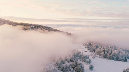 Wall Mural - Drone view of snowy mountain landscape surrounded by clouds