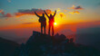 © Sami - Two people silhouette with arms raised up on mountain top at sunset