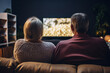 © Tetiana - Elderly couple pensioners spending time together watching tv set generative AI portrait