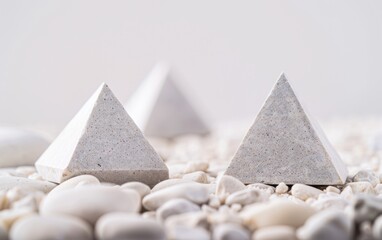 Poster - Abstract Minimalist Composition of Geometric Symbols on White Pebble Background Using Long Exposure and Wide-Angle Lens