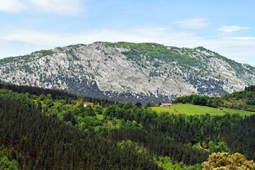 Wall Mural - Farmhouse in the Urkiola Natural Park. At the bottom, Mount Esku