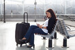 © Song_about_summer - woman using mobile phone smartphone gadget in airport while waiting for her flight, wifi in airport