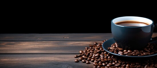 Poster - A top view of a cup of coffee and a bean on a black wooden table creates a captivating copy space image