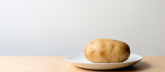 Poster - A potato is boiled and placed on a plate The plate is white and the background is isolated There is empty space for writing texts. with copy space image. Place for adding text or design