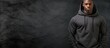 © vxnaghiyev - An advertising banner features a fashionable African American male model wearing a black hoodie and jeans allowing for copy space