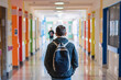 © Di Studio - Back view of teenage boy walking in school corridor