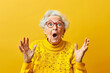 © Di Studio - surprised senior woman over yellow background