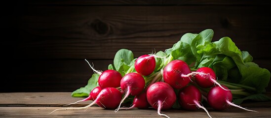 Poster - An image of organic food vegetables specifically red radishes placed on a rustic wooden background with plenty of copy space