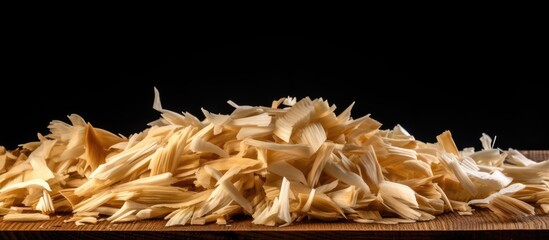 Aufkleber - Copy space image of fresh wood shavings on black background providing an empty space for text