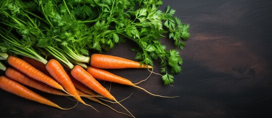 Aufkleber - A top view of a bunch of fresh carrots on a cutting board placed on a dark stone table creating a food concept with copy space image