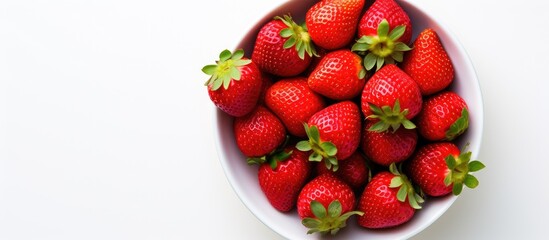 Poster - A close up view from above of a plate of fresh strawberries which are part of a healthy raw diet The image is isolated on a white background and includes copy space for text or framing