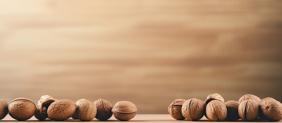Poster - A close up image of wooden bowl filled with halves of walnut kernels placed from above on a colored background This concept represents healthy eating and the inclusion of super foods with copy space f