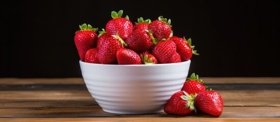 Poster - A close up image of red fresh strawberries arranged in a cup on a table with ample copy space
