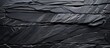 © vxnaghiyev - High resolution top view of a naturally patterned background made of black slate stone The image provides ample copy space