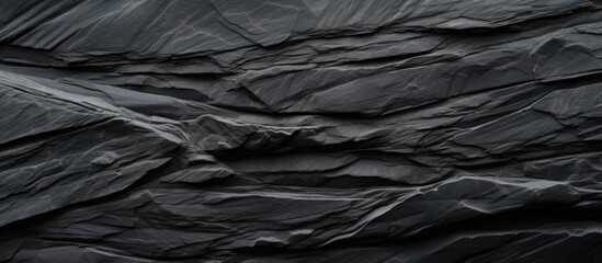 Poster - High resolution top view of a patterned background made of natural black slate stone providing ample copy space image