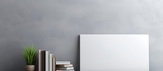 Poster - A copy space image featuring a white notebook opened on a bookshelf against a gray wall showcasing the design concept