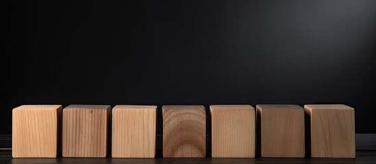 Poster - Black background with copyspace image featuring row of seven blank wooden blocks for your personalized text letters or numbers