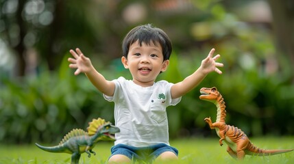 Wall Mural - A cute little boy is playing with toys on the green lawn