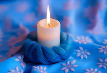 Poster - A white candle on a blue cloth with intricate designs