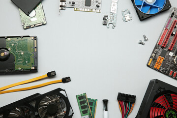 Poster - Frame of graphics card and other computer hardware on light background, flat lay. Space for text