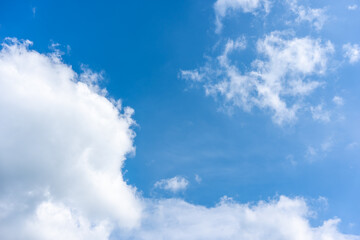 Canvas Print - White fluffy clouds in front of a blue sky