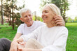 © Богдан Маліцький - elderly couple of seniors man and woman hugging and smiling in the park outdoors, gray-haired grandparents in white T-shirts in nature