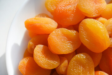 Wall Mural - Dried fruits. Dried apricots. Dried apricots in close-up on a white plate.