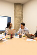 © ADDICTIVE STOCK - Diverse professionals collaborating in a coworking space