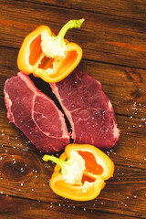 Wall Mural - A piece of premium meat, striploin steak on a wooden table with pepper