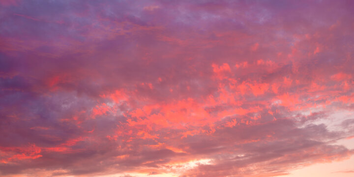 A beautiful pink and orange sky with clouds. The sky is filled with clouds and the sun is setting