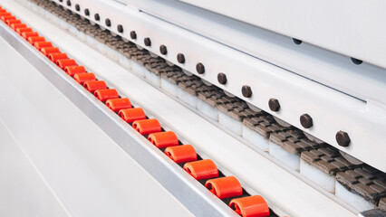 Poster - A conveyor belt with red and white balls on it