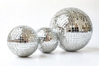 © Rysak - Three silver disco balls on a white background