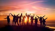 © Neuropixel - A group of people celebrating with raised arms against a vibrant sunset background.
